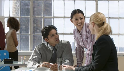 A team consisting of two women and a man running a retrospective